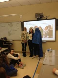 Wellesley High School English teacher Shima Khan with a student from her class wearing a burqa flank local author Elizabeth Suneby