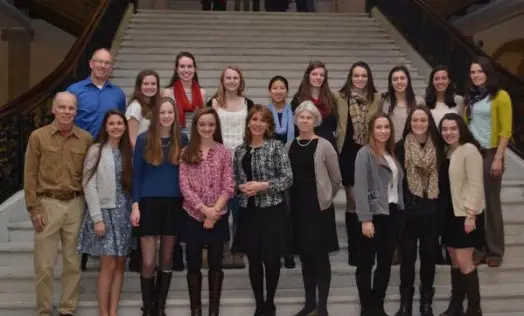 WHS's Champion Nordic Ski Team takes a turn on the grand staircase of the State House with Rep. Alice Peisch. Photo credit to Karen Polito.