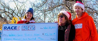 Wellesley Cancer Prevention Project board members Linda Griffith and Theresa Keresztes receiving  check from race organizer J. Alain Ferry
