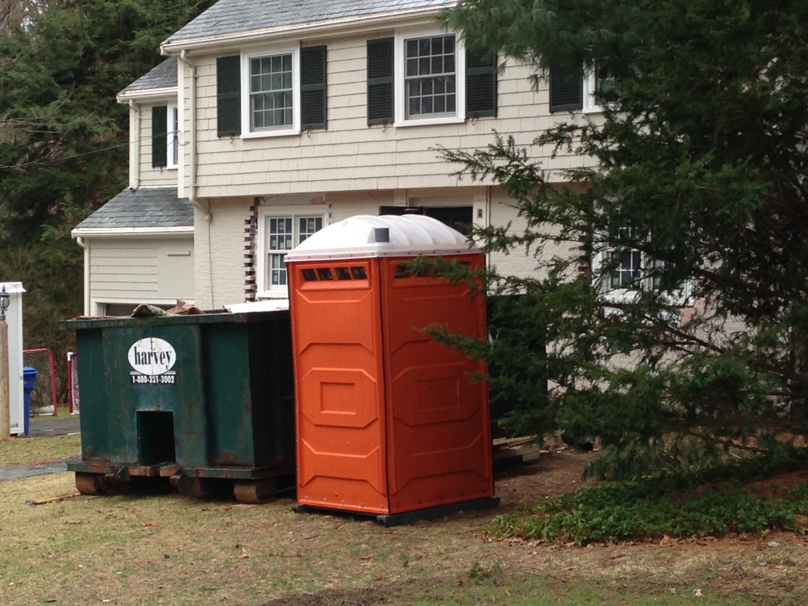 This orange port-a-potty is a welcome pop of color in an early-Spring tableau. 