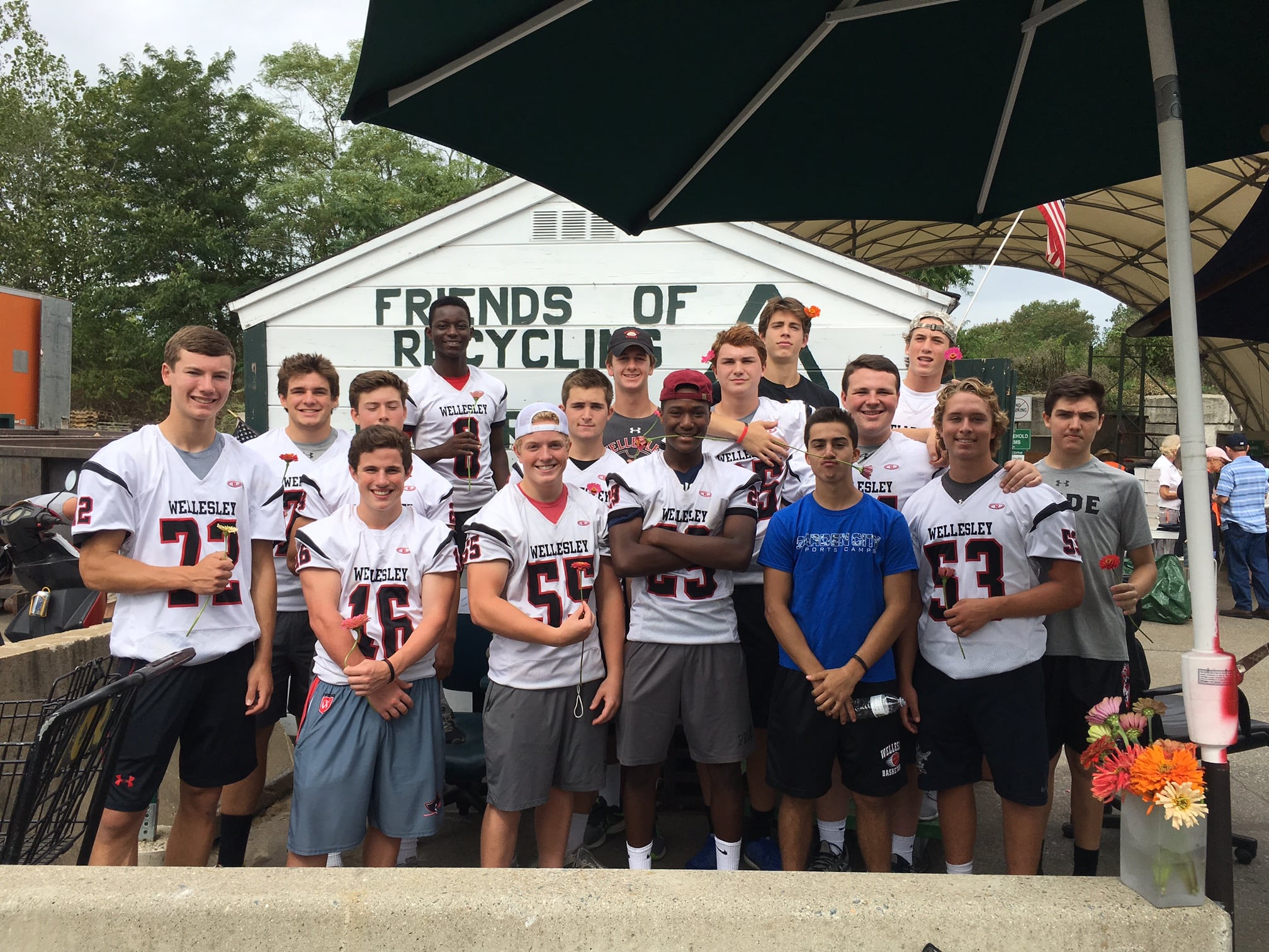 The WHS football team stopped by to help out the RDF volunteers with some heavy work. They weren't too busy to pose for a pic. I handed out a zinnia to each. Some wore them in their hair, some held them in their hands, or their teeth. 