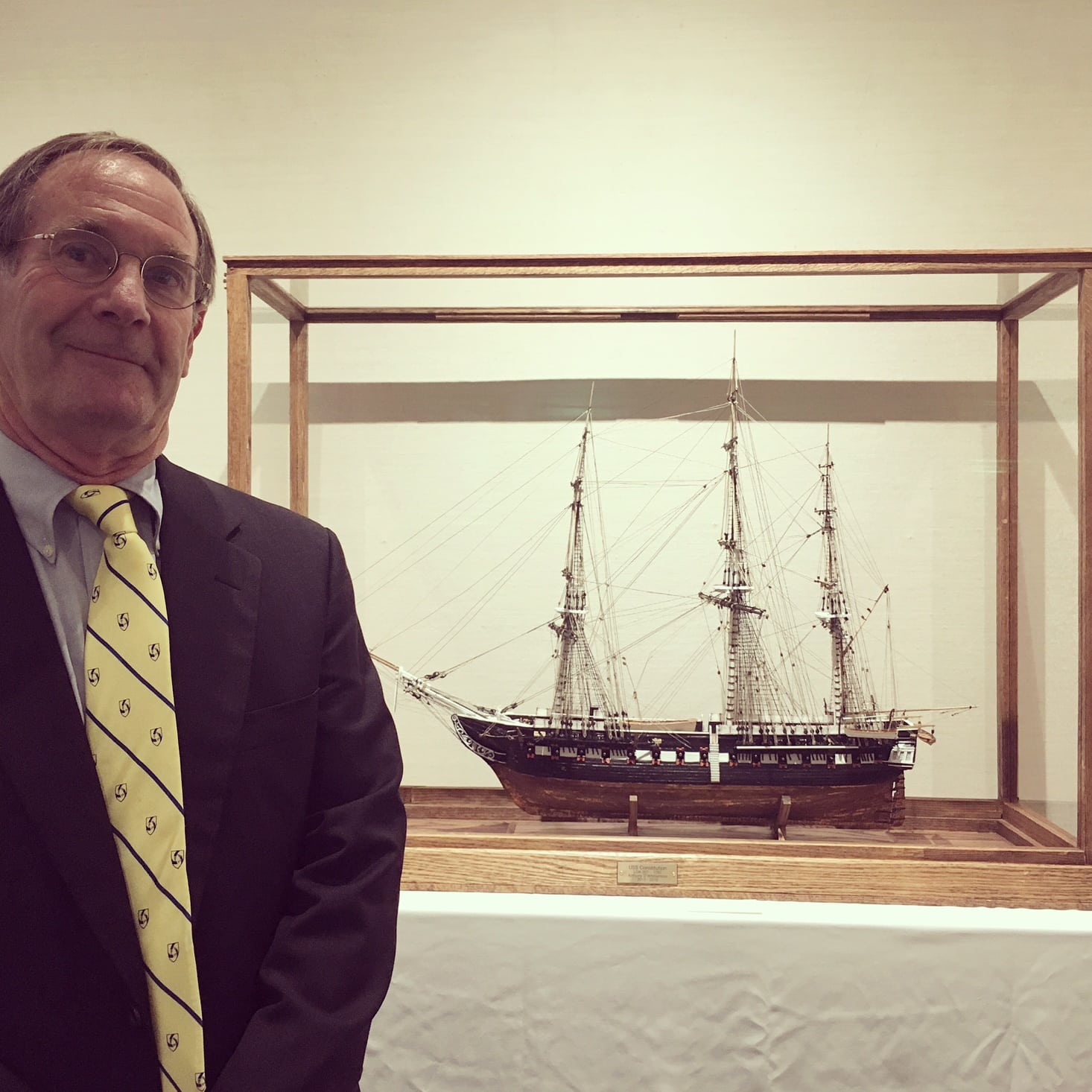 Dr. Anthony Whittemore, sailor and model builder, poses with one of his creations.