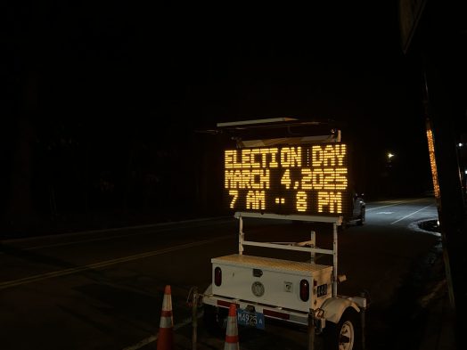 A sign reminding voters that election Day is Tuesday is displayed for drivers.